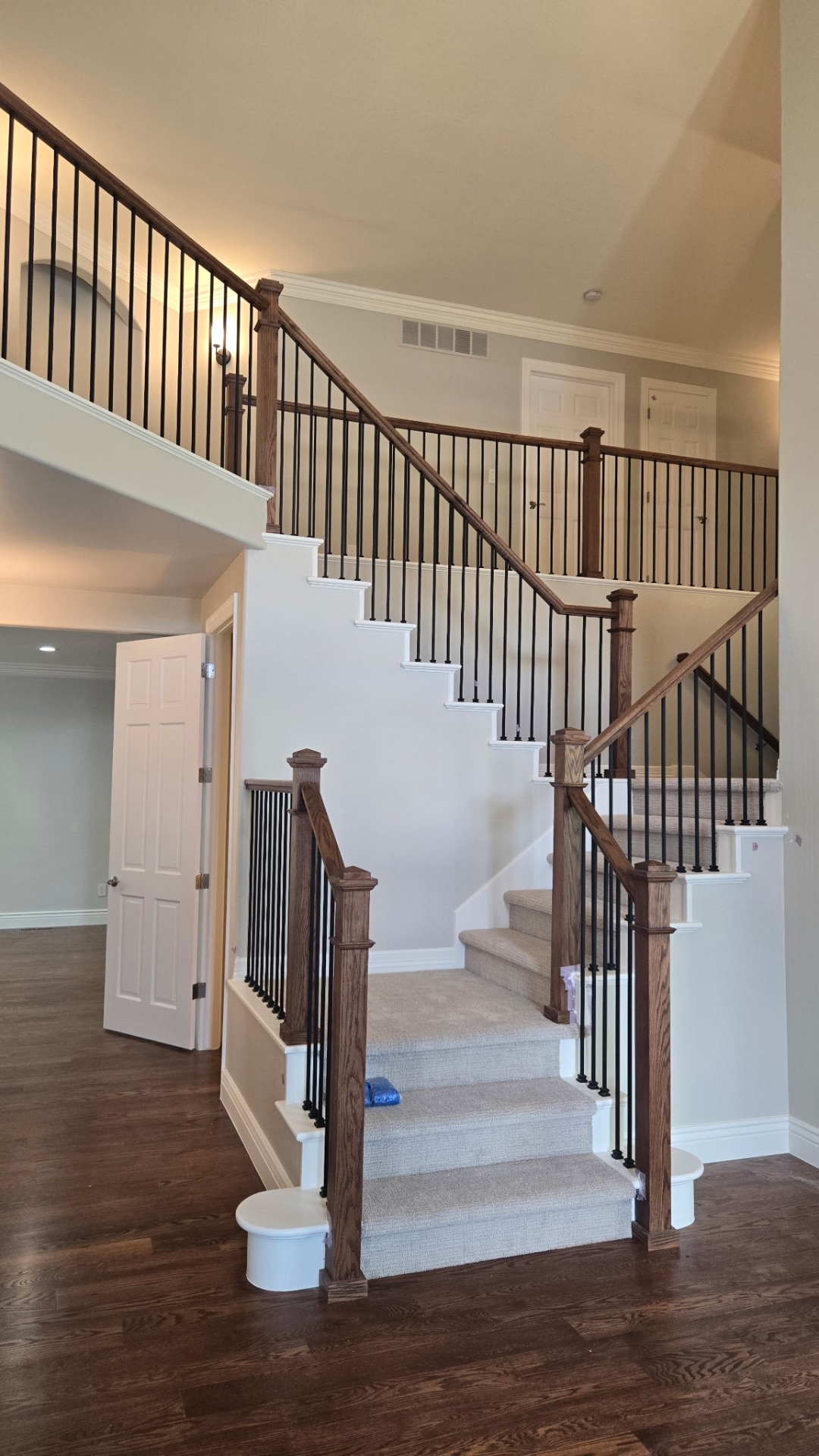 Refinished staircase with stained oak rails and iron balusters
