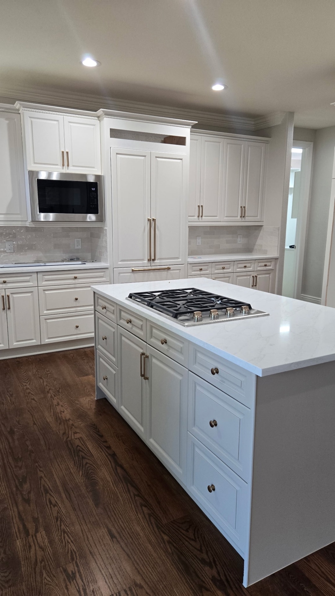 Kitchen island with quartz countertop and gas cooktop